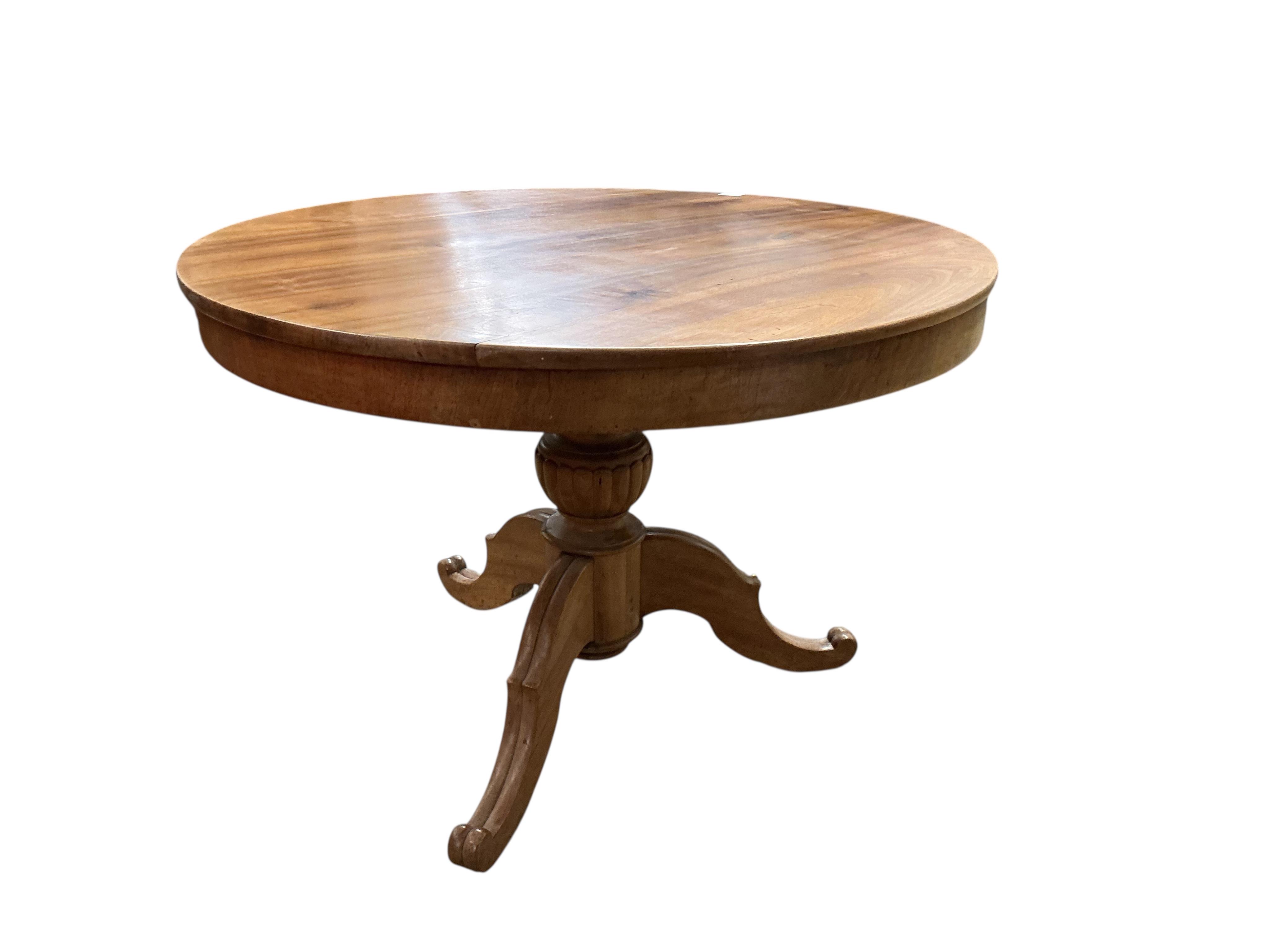 A Swedish circular walnut breakfast table, diameter 107cm, height 76cm together with four dining chairs, one with arms